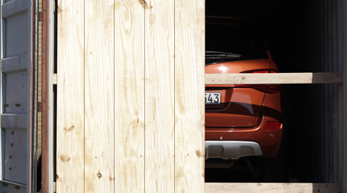 Vehicle being shipped in a container.